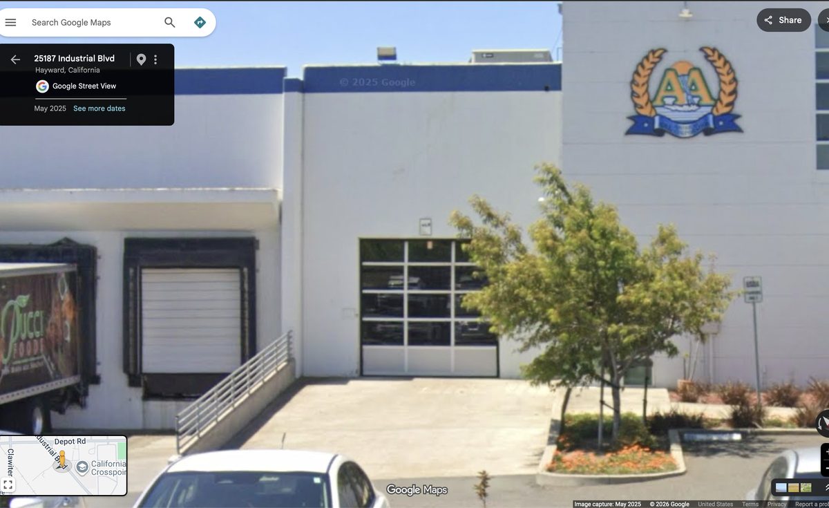 The Pucci Foods building at 25187 Industrial Blvd in Hayward, with a loading dock and roll-up door.